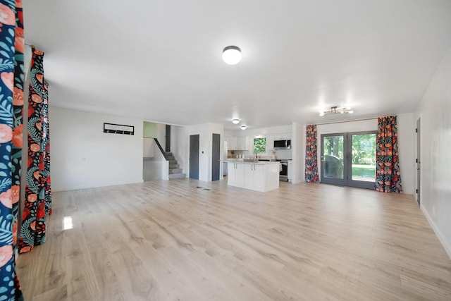 4959 Hughes Rd, Prospect, OH 43342 - unfurnished living room with light wood-type flooring and stairs