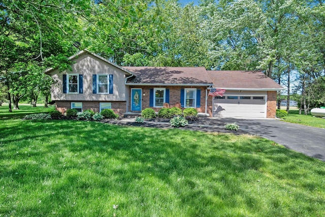 4959 Hughes Rd, Prospect, OH 43342 - split level home featuring an attached garage, asphalt driveway, a front yard, and brick siding