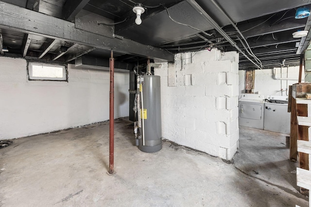 basement featuring gas water heater and independent washer and dryer