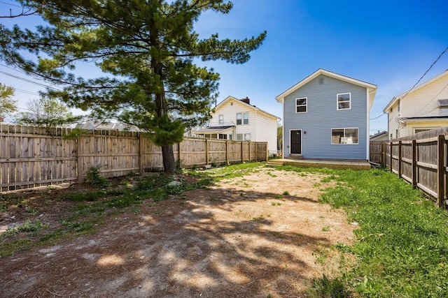 back of property featuring a fenced backyard