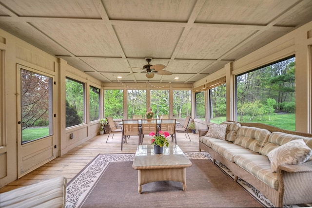 sunroom with wood ceiling, a wealth of natural light, hardwood / wood-style floors, and a deck