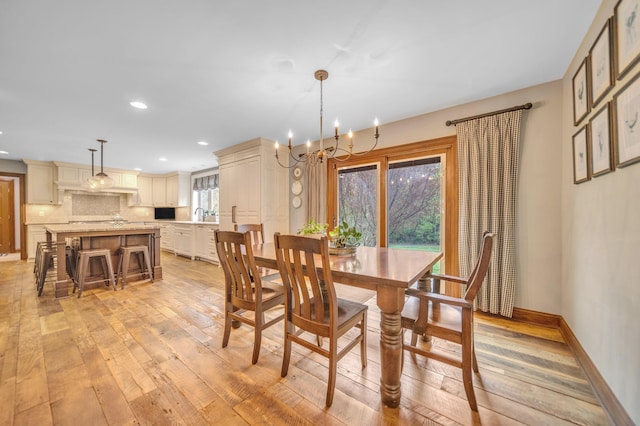 dining room with light wood finished floors, recessed lighting, a chandelier, and baseboards