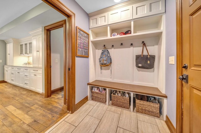 mudroom featuring light wood-style floors and baseboards