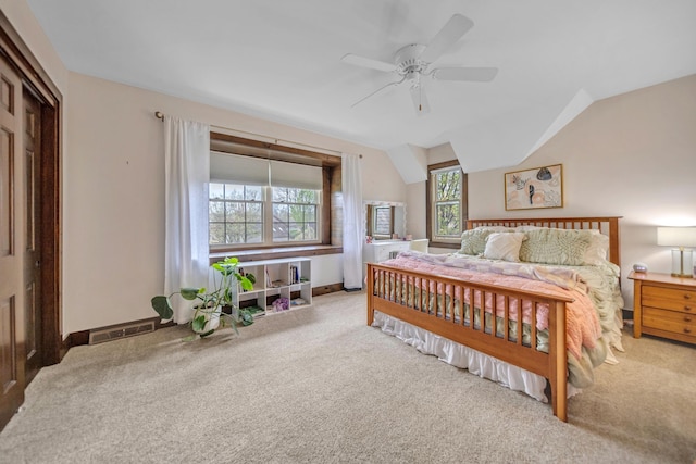 carpeted bedroom with lofted ceiling, visible vents, a ceiling fan, and baseboards
