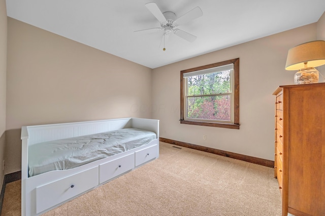 carpeted bedroom with baseboards, visible vents, and a ceiling fan
