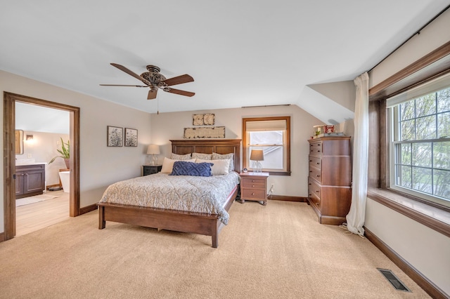 bedroom featuring connected bathroom, light colored carpet, visible vents, baseboards, and a ceiling fan