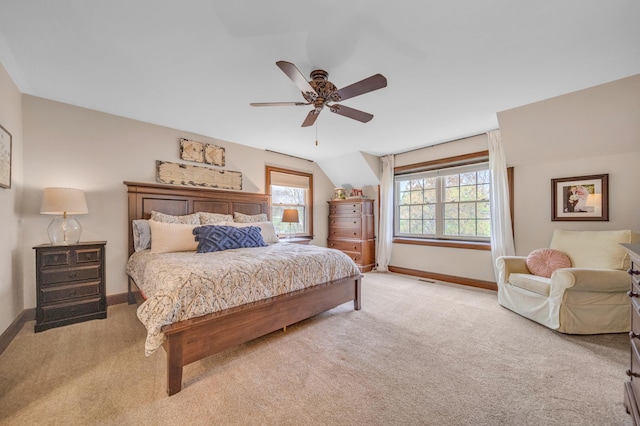 carpeted bedroom with ceiling fan and baseboards