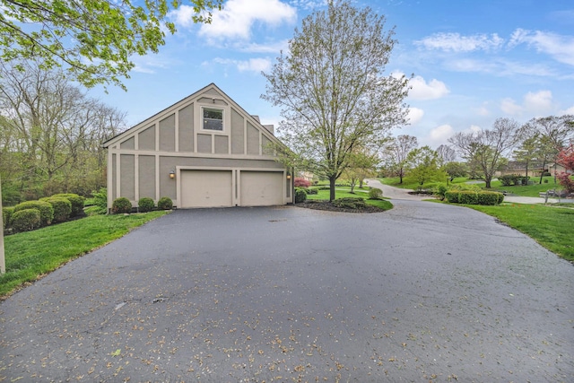 view of side of home with driveway, a yard, and stucco siding