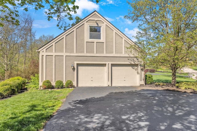 garage featuring aphalt driveway