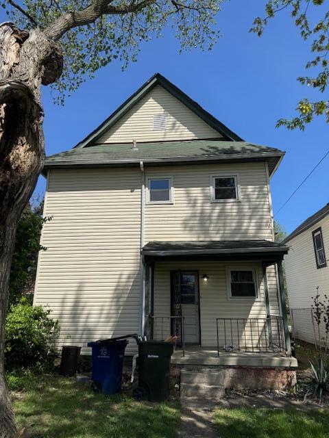 rear view of property with a porch