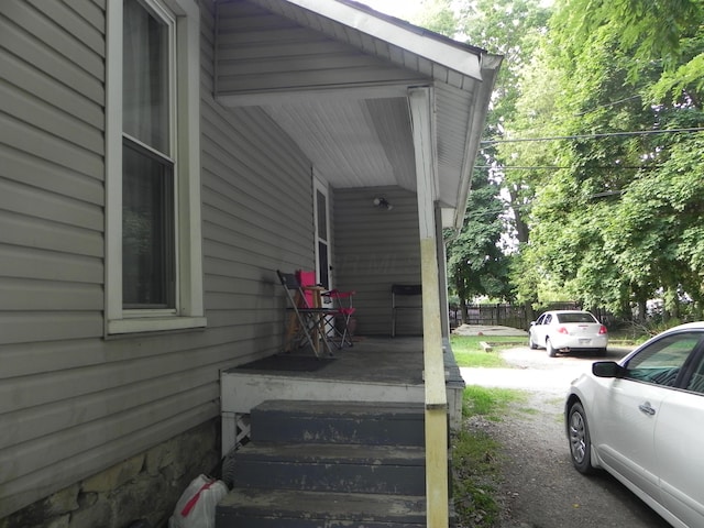 view of side of property with covered porch