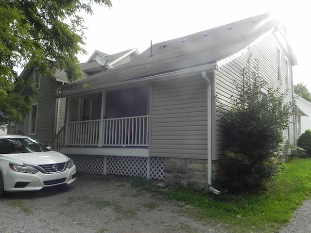 view of property exterior featuring covered porch
