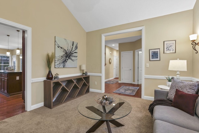 living room with baseboards, vaulted ceiling, dark wood-style floors, and dark colored carpet