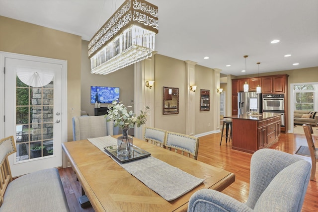 dining room featuring recessed lighting, light wood-style flooring, and baseboards