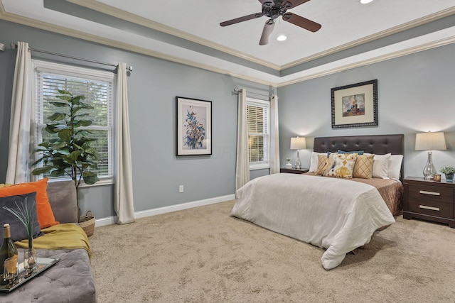 carpeted bedroom with a ceiling fan, crown molding, a raised ceiling, baseboards, and recessed lighting