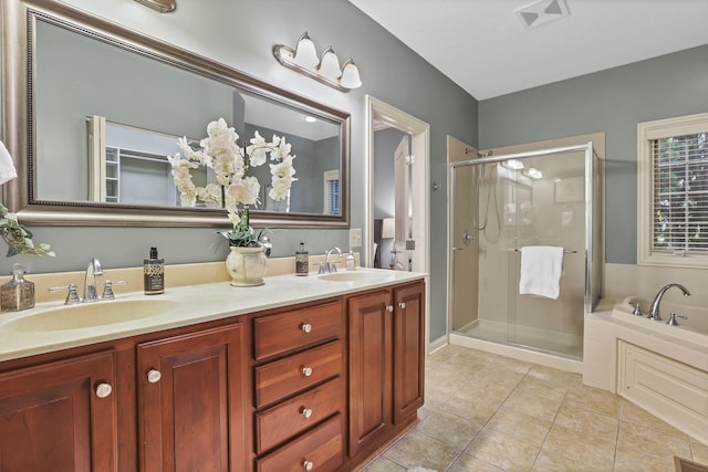 full bath featuring a sink, tile patterned floors, a stall shower, and a bath