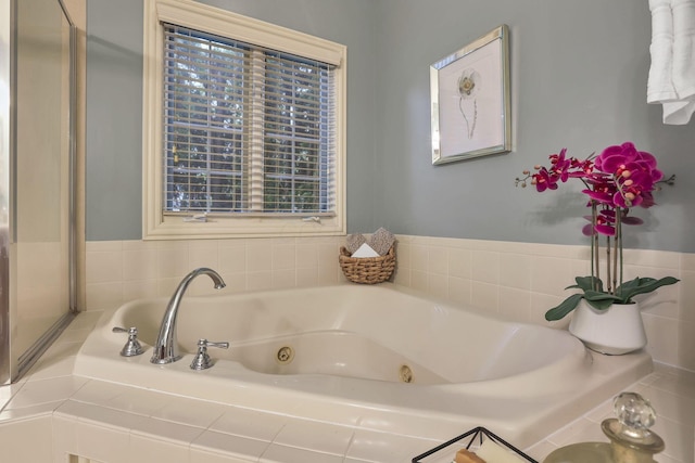 full bathroom with a whirlpool tub