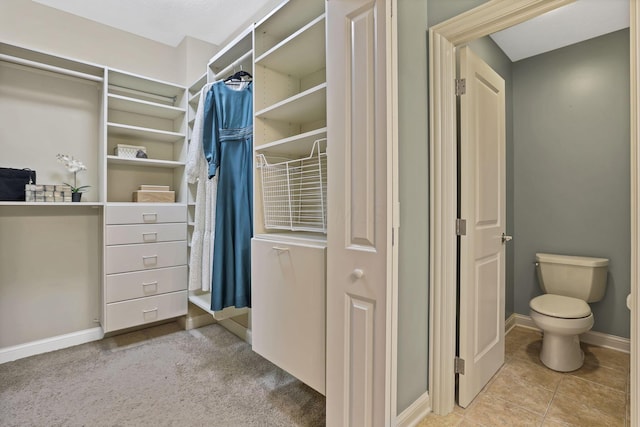 spacious closet with tile patterned floors