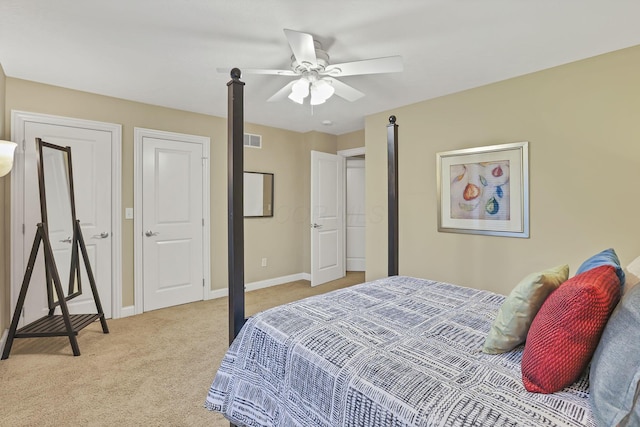 bedroom featuring a ceiling fan, baseboards, light colored carpet, and visible vents