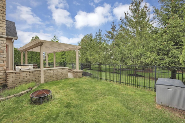 view of yard with fence private yard, a fire pit, and a pergola
