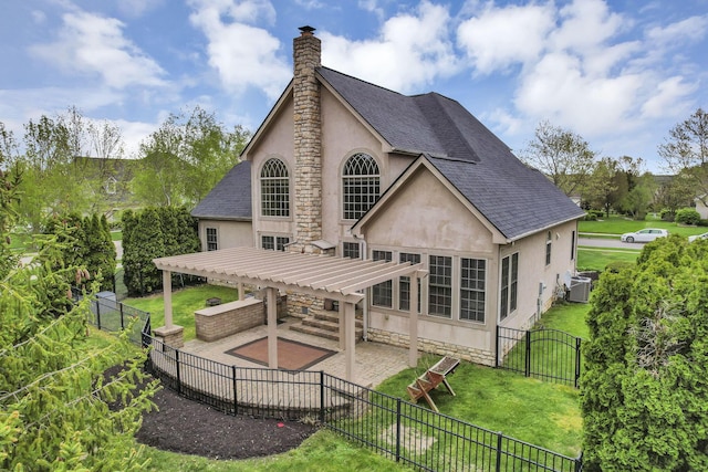 back of house with roof with shingles, a pergola, stucco siding, and a patio area