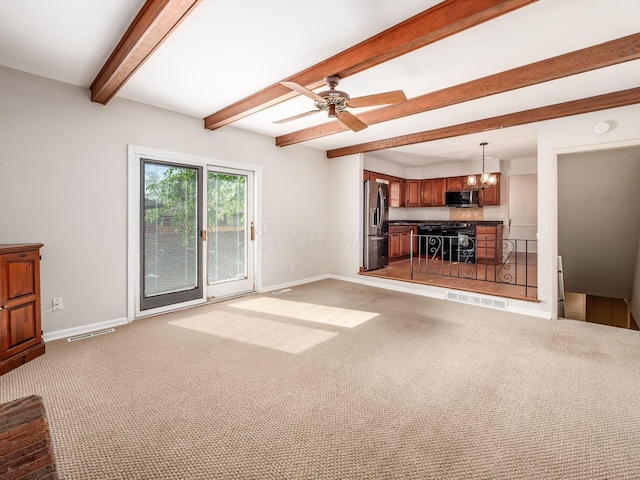 unfurnished living room with baseboards, beam ceiling, visible vents, and light colored carpet