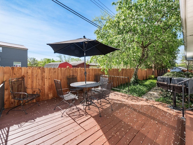 wooden terrace with fence and outdoor dining space