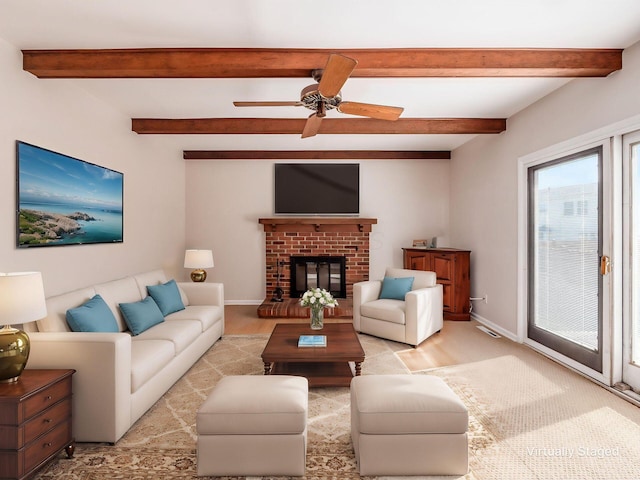 living room with ceiling fan, a fireplace, light wood-style flooring, baseboards, and beamed ceiling