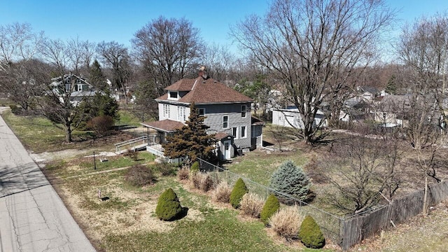 view of home's exterior with fence and a chimney