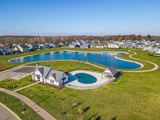 view of pool featuring a residential view, a water view, and a yard