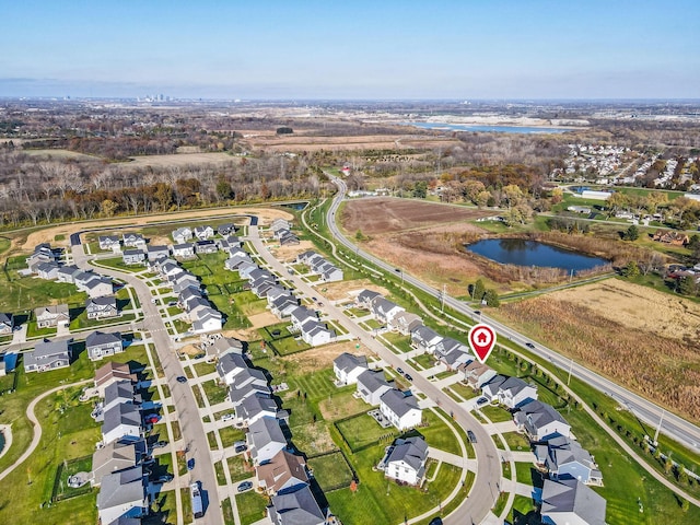 birds eye view of property featuring a water view and a residential view