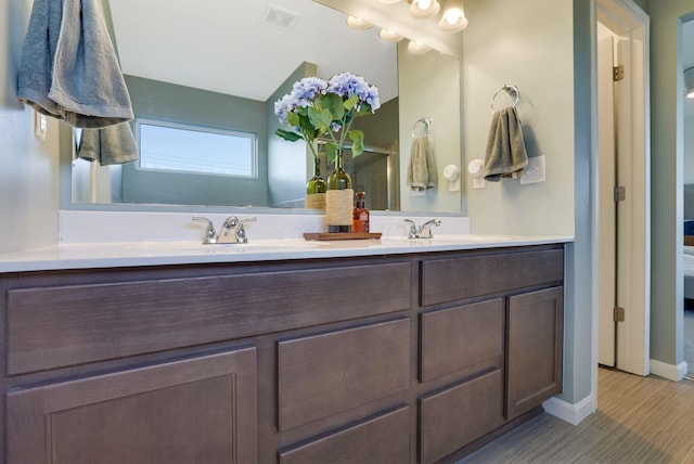 ensuite bathroom with a sink, ensuite bath, double vanity, and visible vents