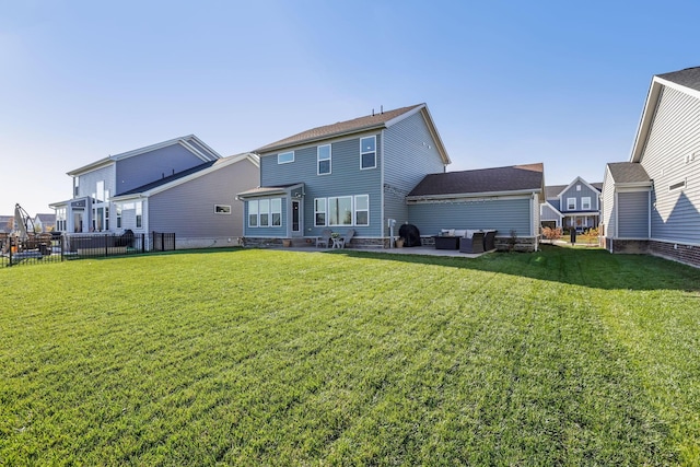 rear view of house featuring a lawn, a patio area, fence, and an outdoor hangout area