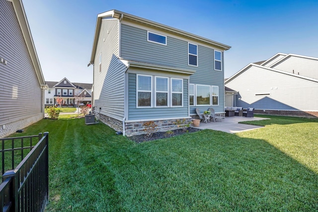 rear view of property featuring a patio, an outdoor living space, fence, and a yard