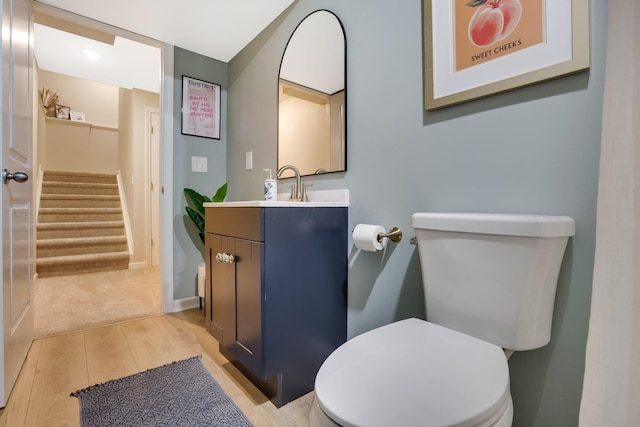 bathroom featuring vanity, wood finished floors, and toilet