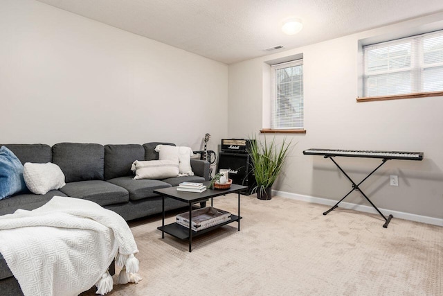 living area featuring baseboards, light colored carpet, and visible vents