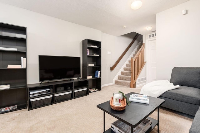 carpeted living area featuring visible vents and stairway