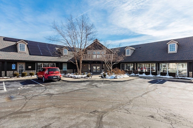 view of property featuring uncovered parking