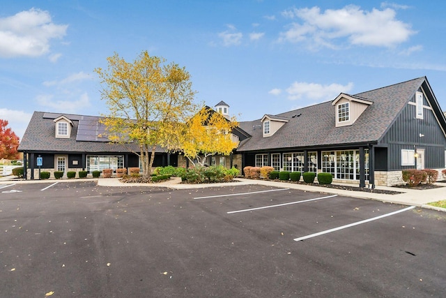 view of building exterior with uncovered parking