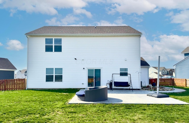 back of property with a lawn, a patio, and fence
