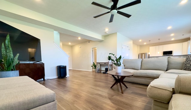 living room featuring baseboards, a ceiling fan, recessed lighting, and wood finished floors
