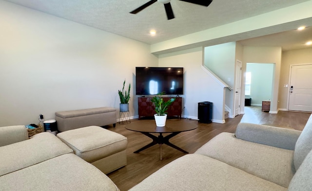 living area featuring stairs, wood finished floors, baseboards, recessed lighting, and a ceiling fan