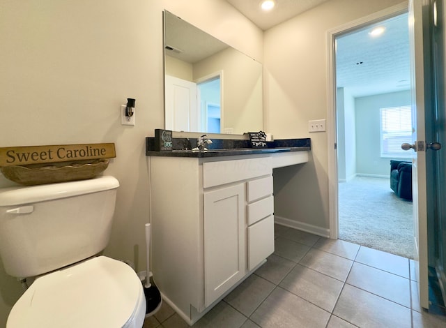 bathroom with toilet, baseboards, visible vents, and tile patterned floors