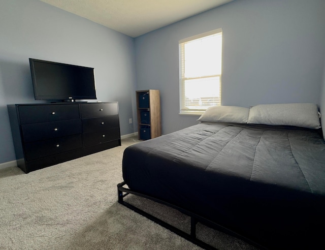 carpeted bedroom with baseboards