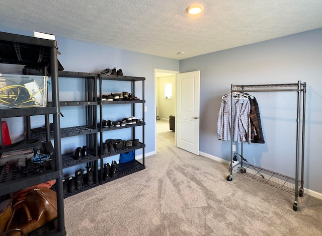 carpeted bedroom with a textured ceiling and baseboards
