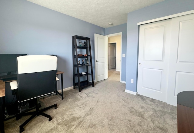 office area featuring carpet flooring, a textured ceiling, and baseboards