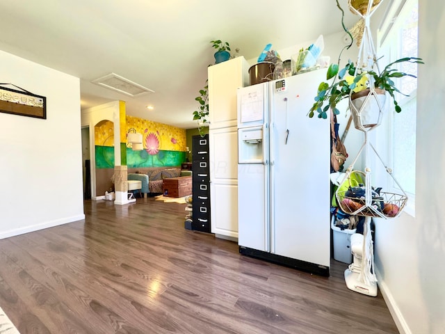 kitchen with baseboards, dark wood-style floors, and white refrigerator with ice dispenser