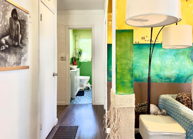 bathroom featuring toilet, baseboards, and wood finished floors