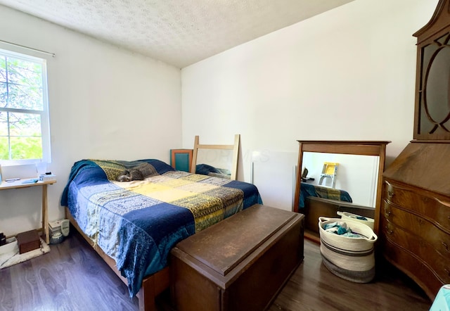 bedroom featuring a textured ceiling and wood finished floors