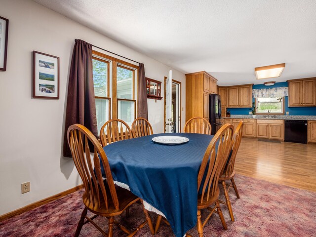 1305 Cooperriders Rd NW, Somerset, OH 43783 - dining room with a textured ceiling, baseboards, and light wood finished floors
